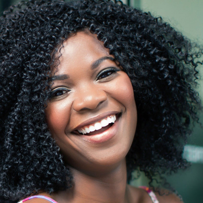 Close-up of a woman smiling to illustrate our dermal filler FAQ and nasolabial folds