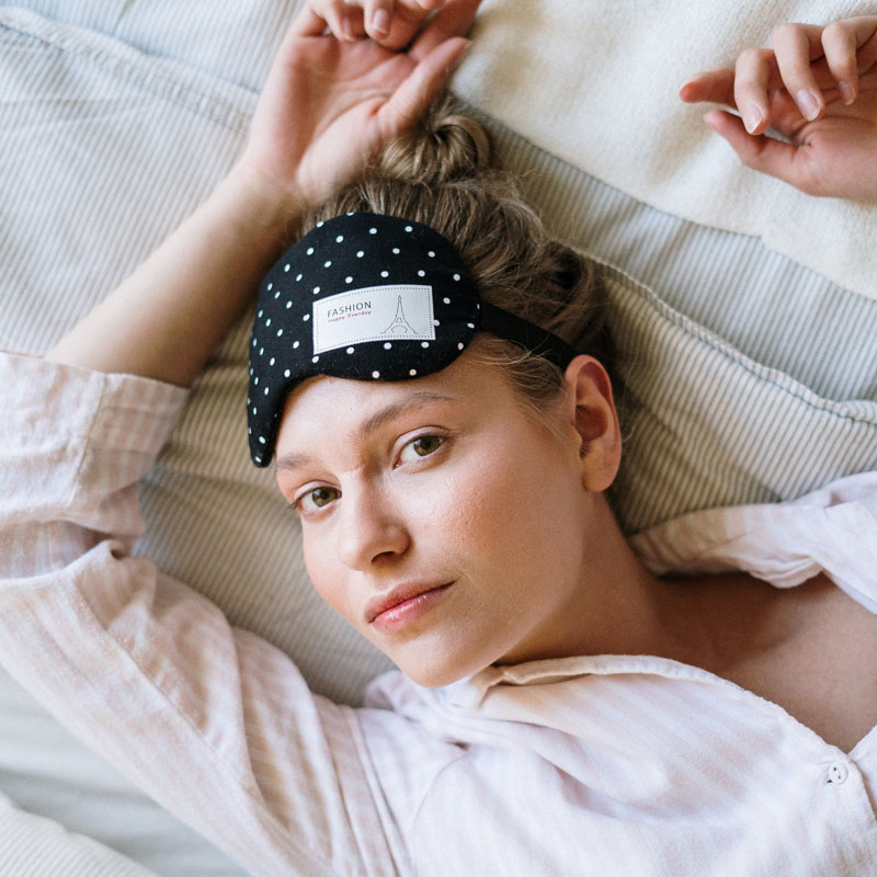 Lady with sleeping mask on her forehead to illustrate perimenopause insomnia and pellet therapy